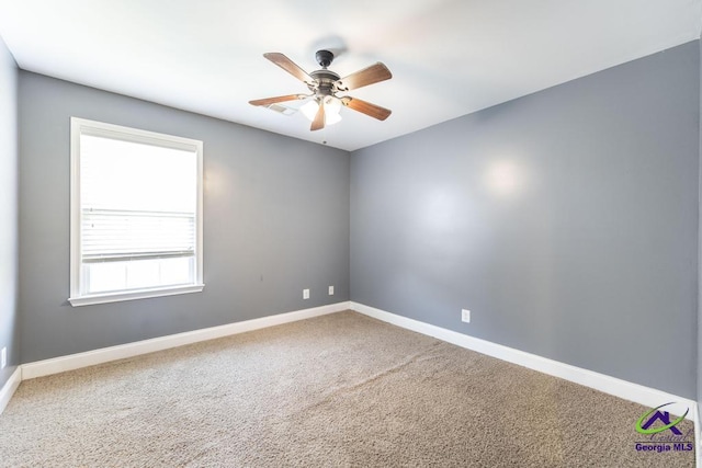 carpeted spare room featuring ceiling fan