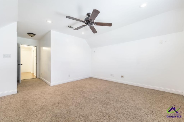 carpeted spare room featuring ceiling fan and lofted ceiling