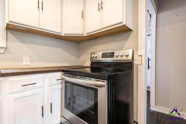 311 Riverside Dr, Hawkinsville, GA 31036 - kitchen with white cabinetry, baseboards, and stainless steel electric range