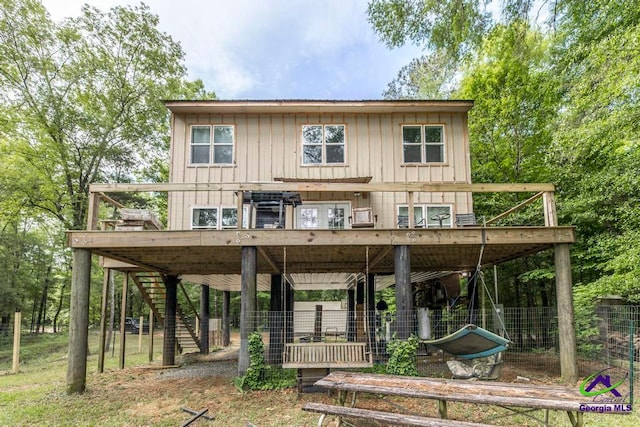 311 Riverside Dr, Hawkinsville, GA 31036 - view of front of home featuring board and batten siding, a wooden deck, and stairs
