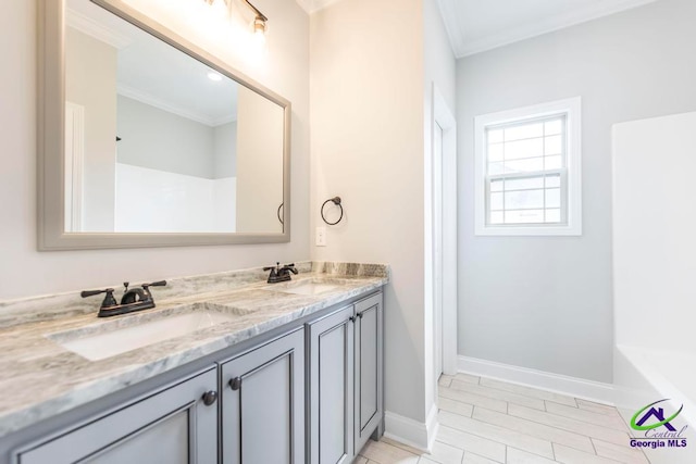 bathroom with a washtub, vanity, and ornamental molding