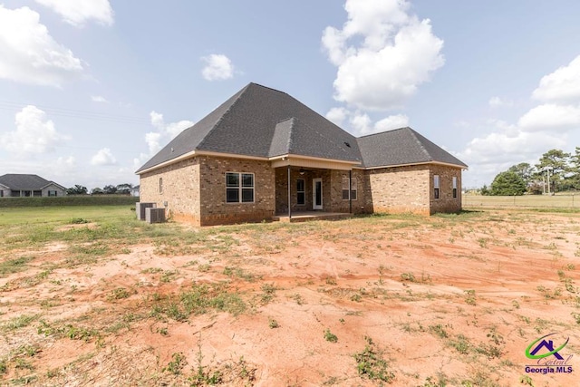 rear view of house with central AC unit