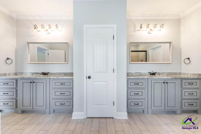 bathroom with hardwood / wood-style floors, vanity, and ornamental molding