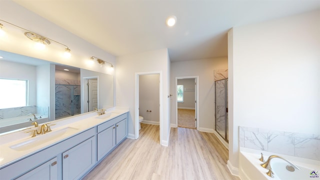 full bathroom featuring double vanity, plus walk in shower, and toilet