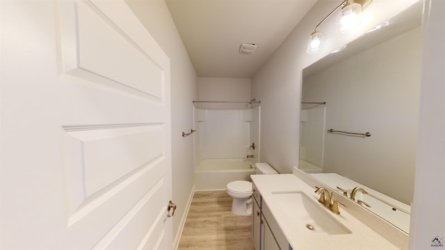 full bathroom featuring hardwood / wood-style flooring,  shower combination, vanity, and toilet