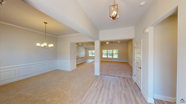 carpeted empty room featuring an inviting chandelier