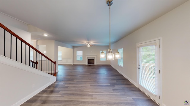 unfurnished living room with ceiling fan and hardwood / wood-style floors