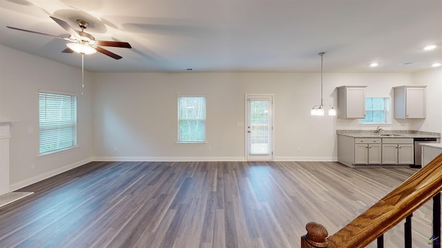 unfurnished living room featuring sink, ceiling fan, and light hardwood / wood-style floors