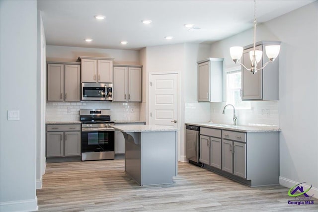 219 Carsons Walk, Macon, GA 31216 - kitchen with decorative backsplash, gray cabinets, a sink, and appliances with stainless steel finishes
