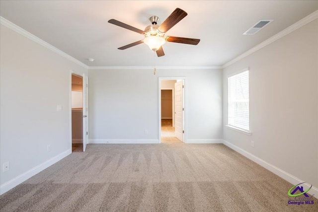 219 Carsons Walk, Macon, GA 31216 - unfurnished bedroom featuring baseboards, ornamental molding, light carpet, a walk in closet, and visible vents