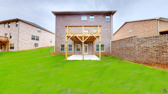 back of property with a balcony, a patio area, and a lawn