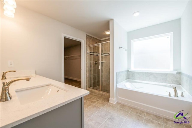 219 Carsons Walk, Macon, GA 31216 - full bath with a stall shower, a spacious closet, tile patterned flooring, a bath, and a sink
