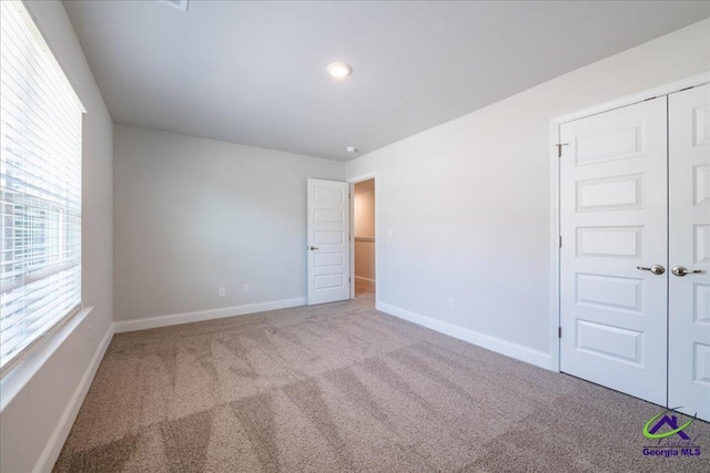 219 Carsons Walk, Macon, GA 31216 - unfurnished bedroom featuring a closet, carpet, and baseboards