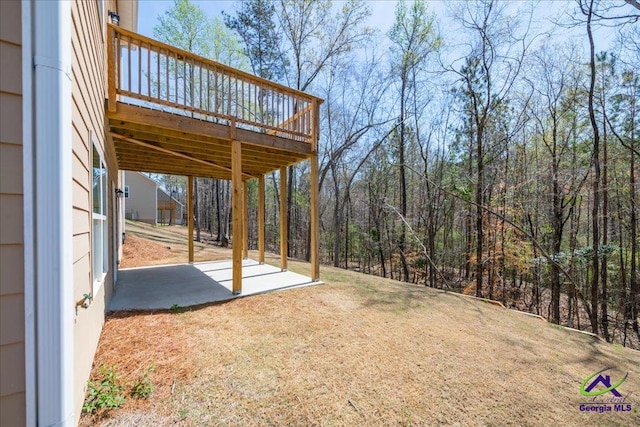 219 Carsons Walk, Macon, GA 31216 - view of yard featuring a wooded view, a patio area, and a wooden deck