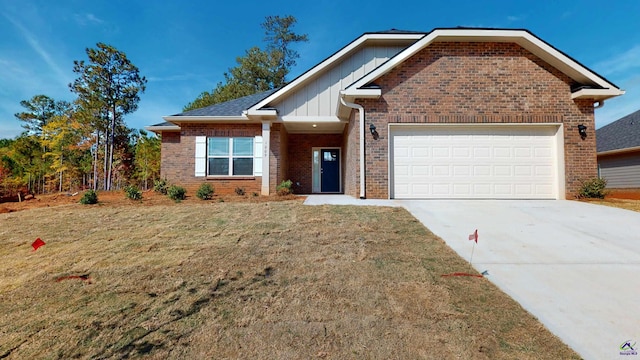 view of front of property featuring a garage and a front lawn