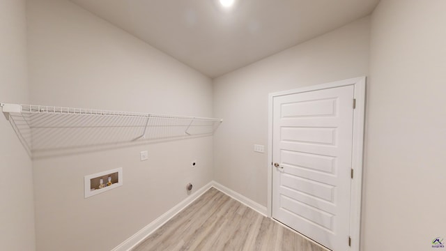 clothes washing area featuring hookup for a washing machine, hookup for an electric dryer, and light wood-type flooring