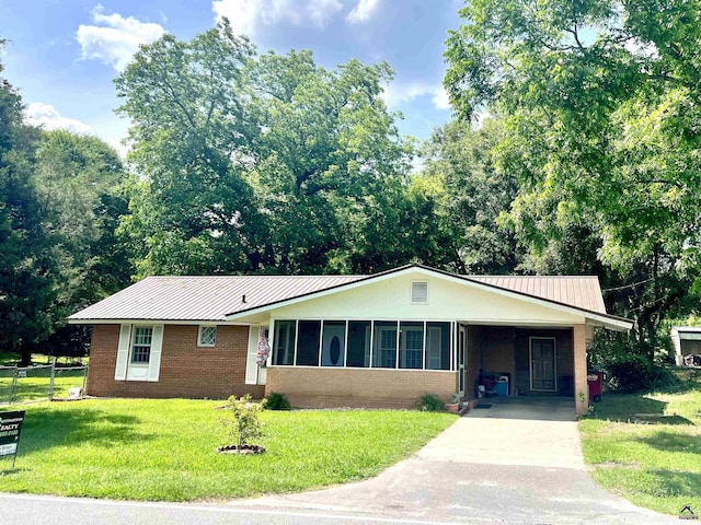 ranch-style house with a front yard and a carport