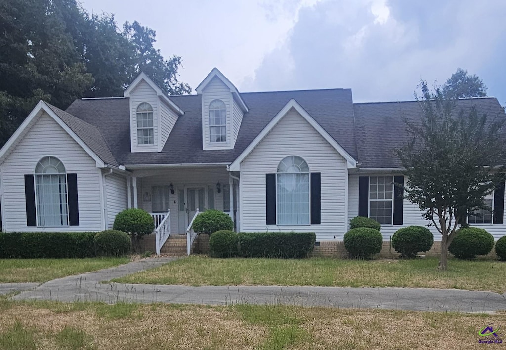 view of front of home with covered porch and a front yard