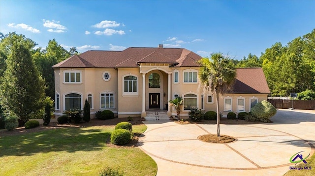 mediterranean / spanish-style house featuring a front yard