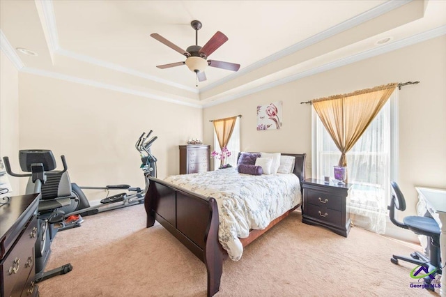 carpeted bedroom featuring ceiling fan, a raised ceiling, and ornamental molding