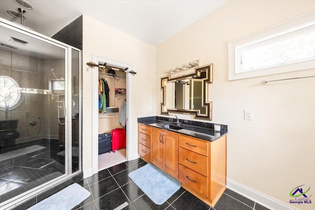 bathroom featuring an enclosed shower, tile flooring, and large vanity