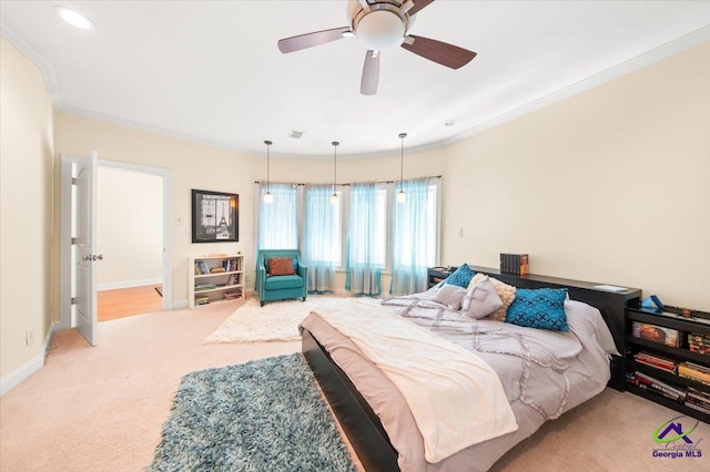 bedroom with carpet, ceiling fan, and crown molding