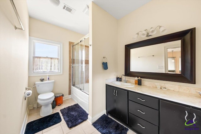 full bathroom with tile floors, combined bath / shower with glass door, vanity, and toilet