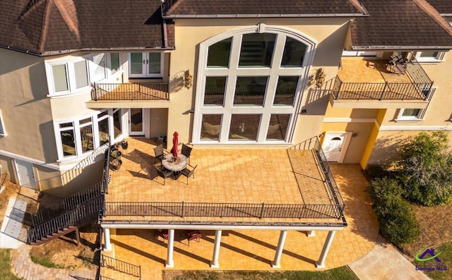 back of house featuring a balcony