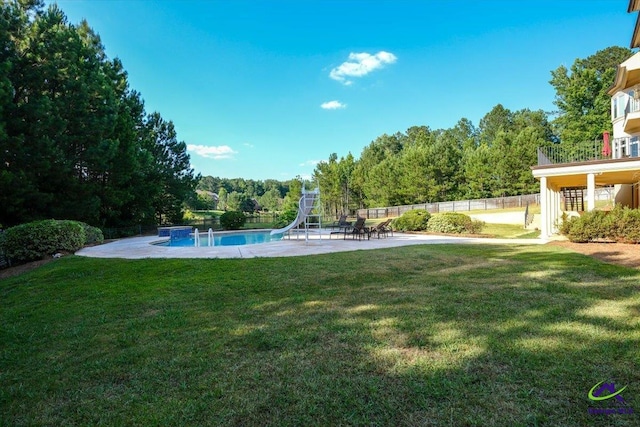 exterior space featuring a lawn, a water slide, and a patio area