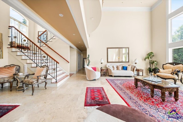 tiled living room featuring a towering ceiling and ornamental molding