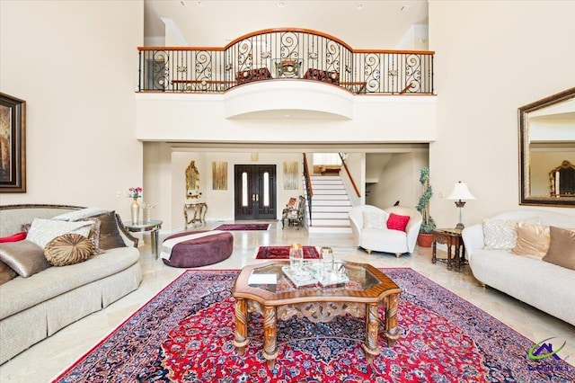 living room featuring a high ceiling and french doors