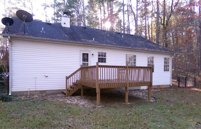 back of house featuring crawl space, a chimney, a deck, and a lawn