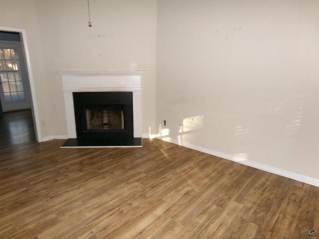 unfurnished living room featuring hardwood / wood-style flooring