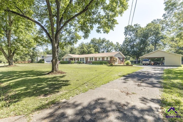 ranch-style house with a front yard and a carport