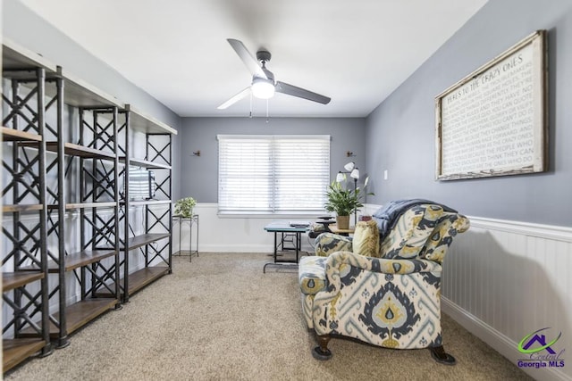 living area with ceiling fan and carpet floors