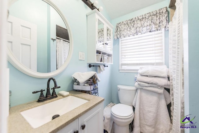 bathroom featuring toilet and vanity