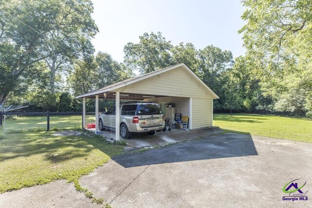 view of vehicle parking with a yard and a carport