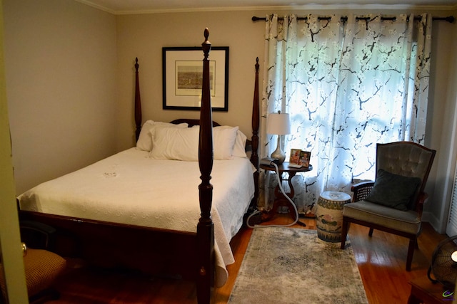 bedroom with wood-type flooring and ornamental molding