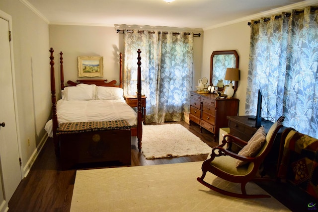 bedroom featuring ornamental molding, multiple windows, and wood-type flooring