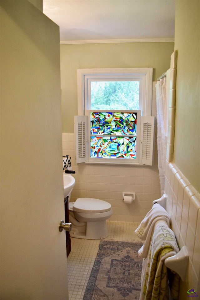 bathroom featuring ornamental molding, tile walls, toilet, and tile patterned floors