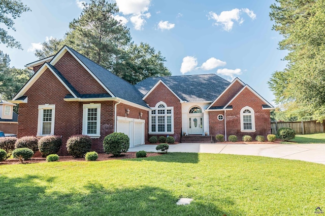 front facade featuring a garage and a front lawn