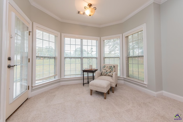 sitting room featuring crown molding and carpet floors