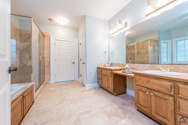 bathroom with a shower with shower door and vanity