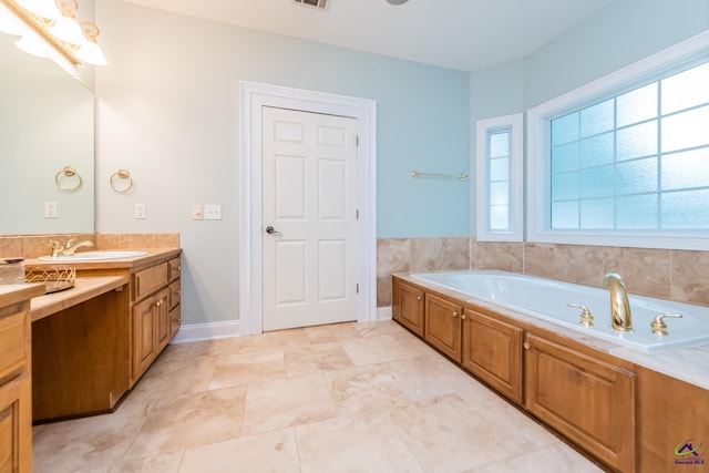 bathroom featuring a washtub and vanity