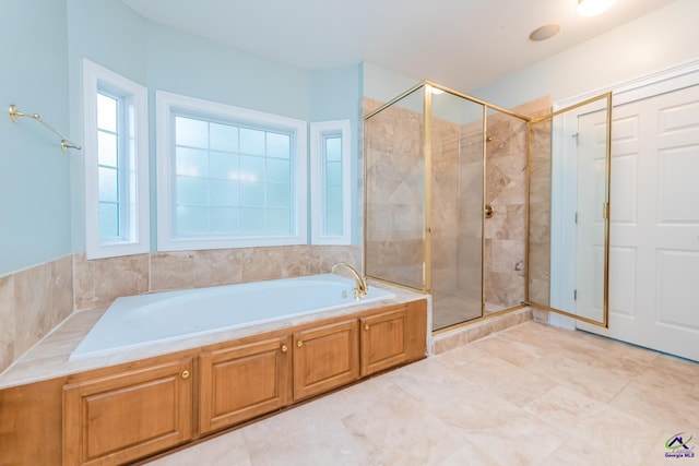 bathroom featuring independent shower and bath