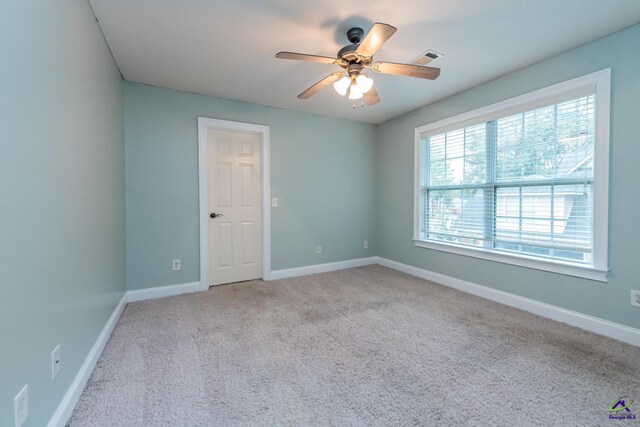 empty room featuring light carpet and ceiling fan