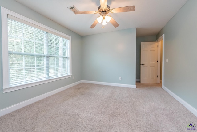 carpeted empty room featuring ceiling fan