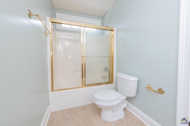 bathroom featuring tile patterned floors, shower / bath combination with glass door, and toilet