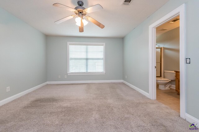 empty room with ceiling fan and light colored carpet