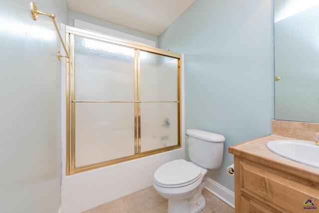 full bathroom with tile patterned floors, enclosed tub / shower combo, vanity, and toilet